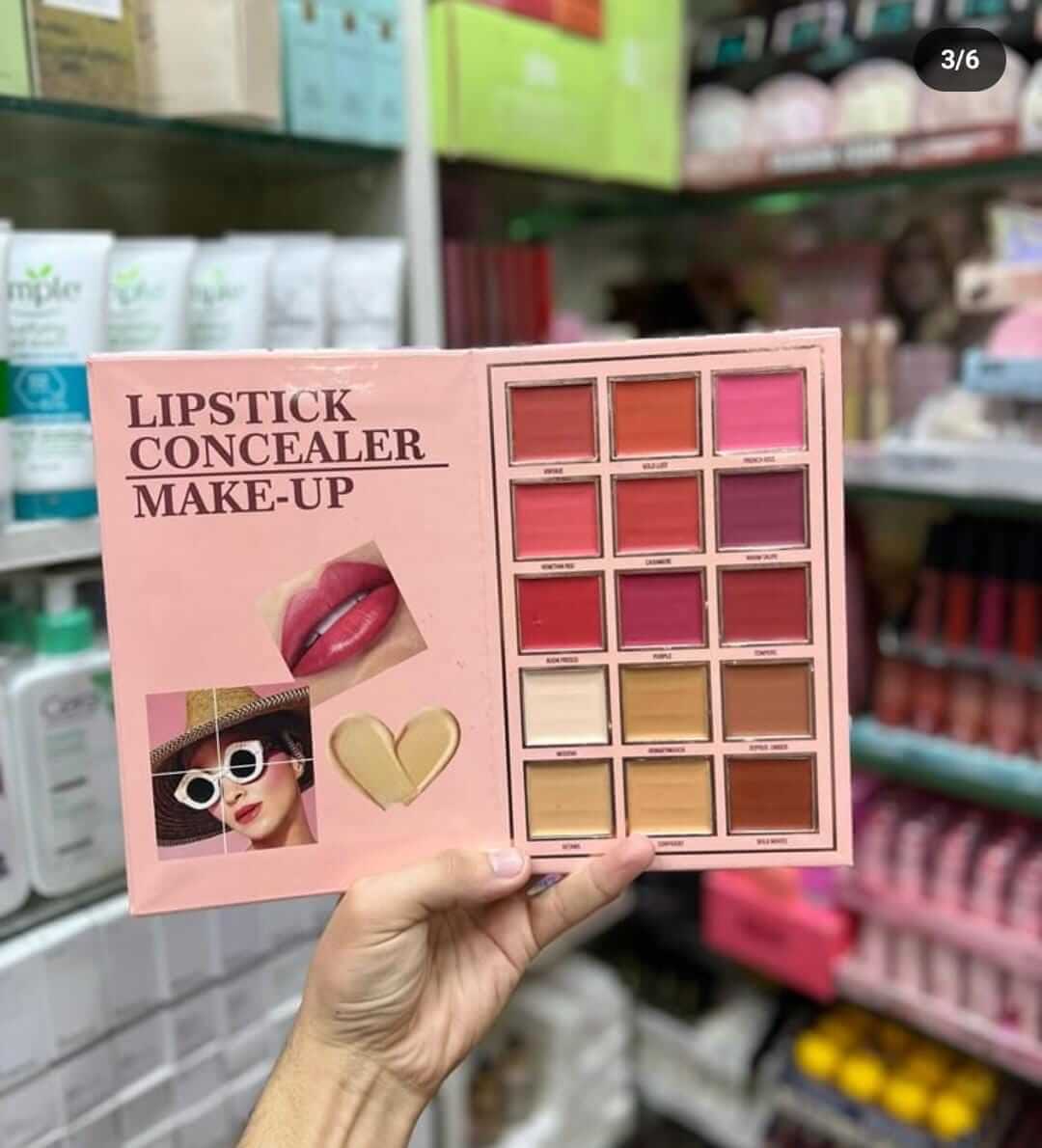 Open makeup palette featuring lipsticks and concealers, held in hand with beauty products in the background.