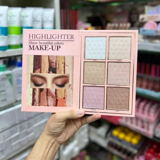 Hand holding a highlighter palette featuring six shades, showcasing beautiful colors for makeup enhancement.